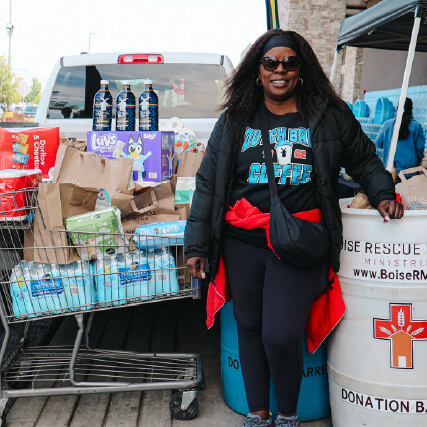 Woman standing next to collected donations