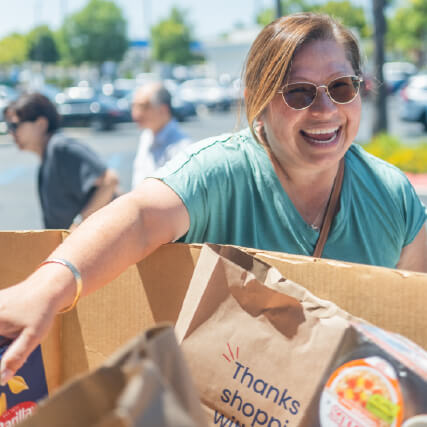 Woman carrying in donations